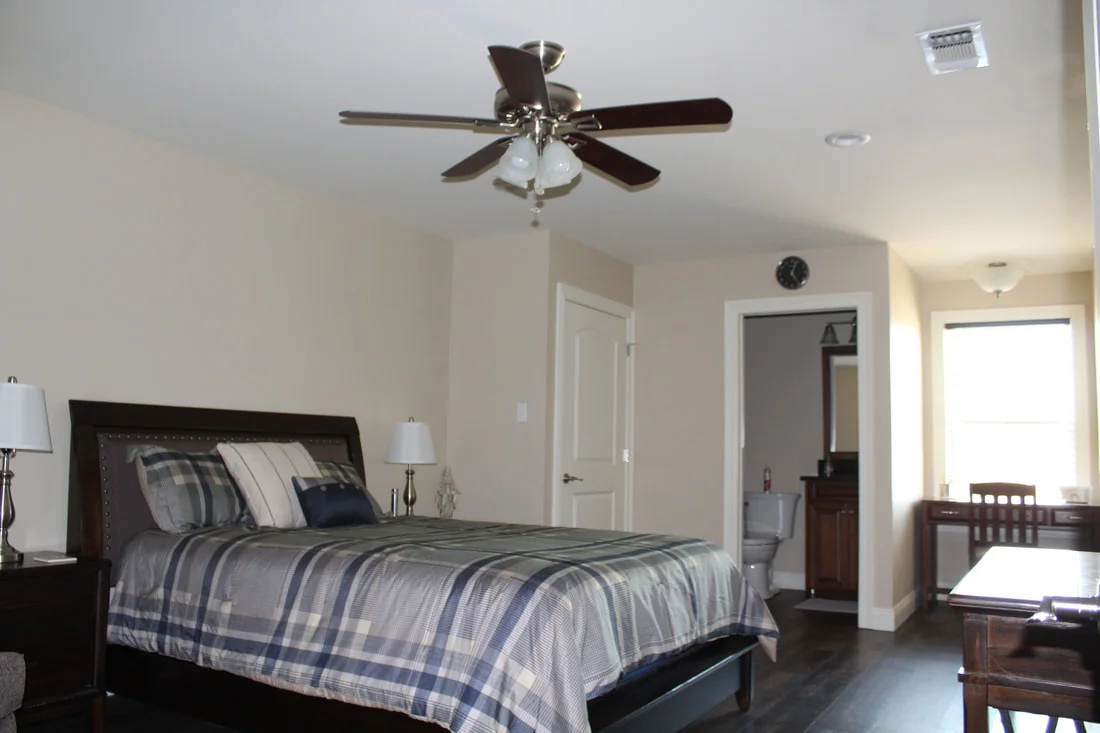 Private Vianney Villa bedroom with sitting area and full bath entrance